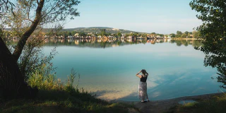 A person exploring the shore of Lake Palatinus outside Esztergom.