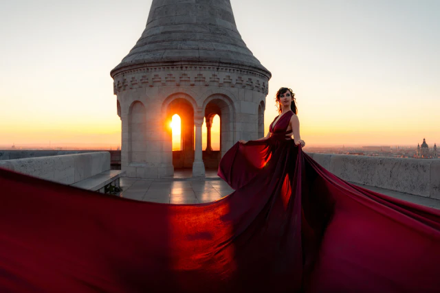 A woman in a long burgundy dress at Fisherman’s Bastion at sunrise
