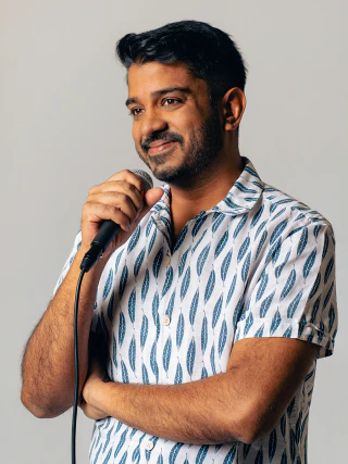 Male brand portrait with a microphone against a bright background