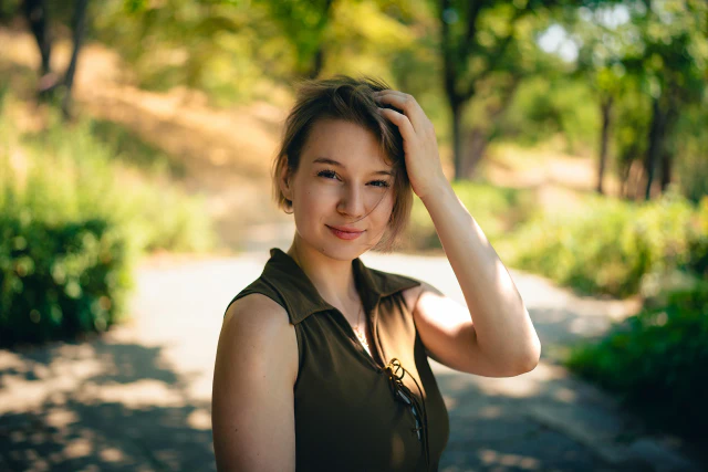 Natural-light outdoor portrait of a smiling young woman in a park